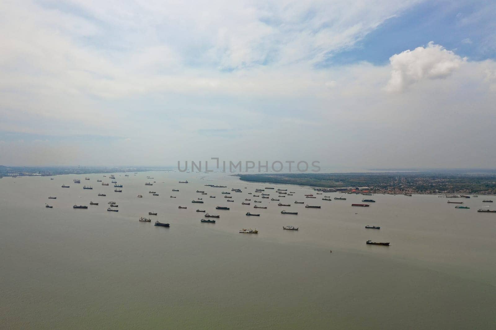 aerial view cargo and passenger seaport with ships Tanjung Perak, surabaya, indonesia. cargo and merchant ships in harbor. trading vessels in the bay awaiting loading and unloading at the seaport