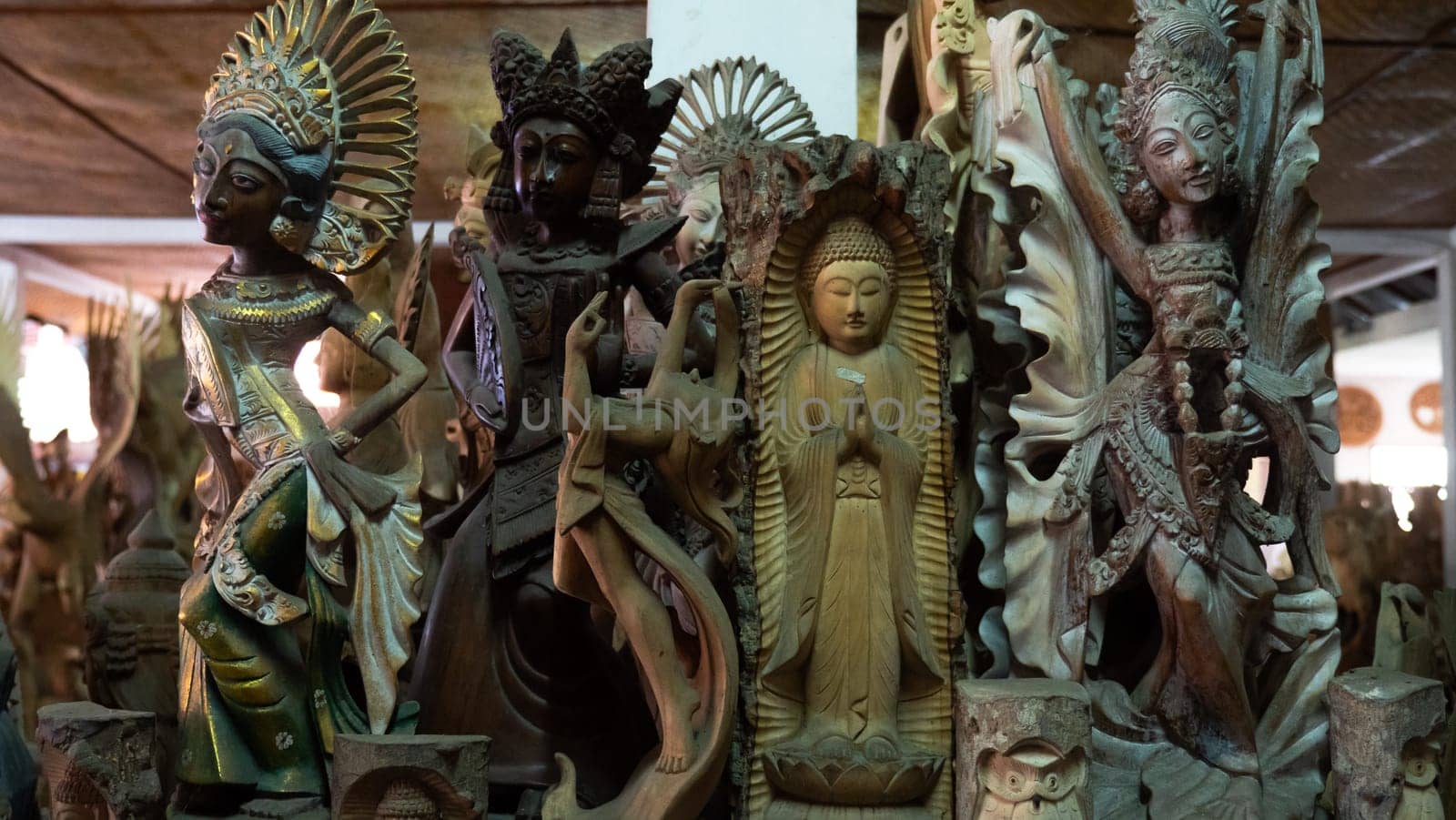 Hindu and Buddhist wooden carving. souvenir shop selling souvenirs and handicrafts of Bali at famous Ubud Market, Indonesia