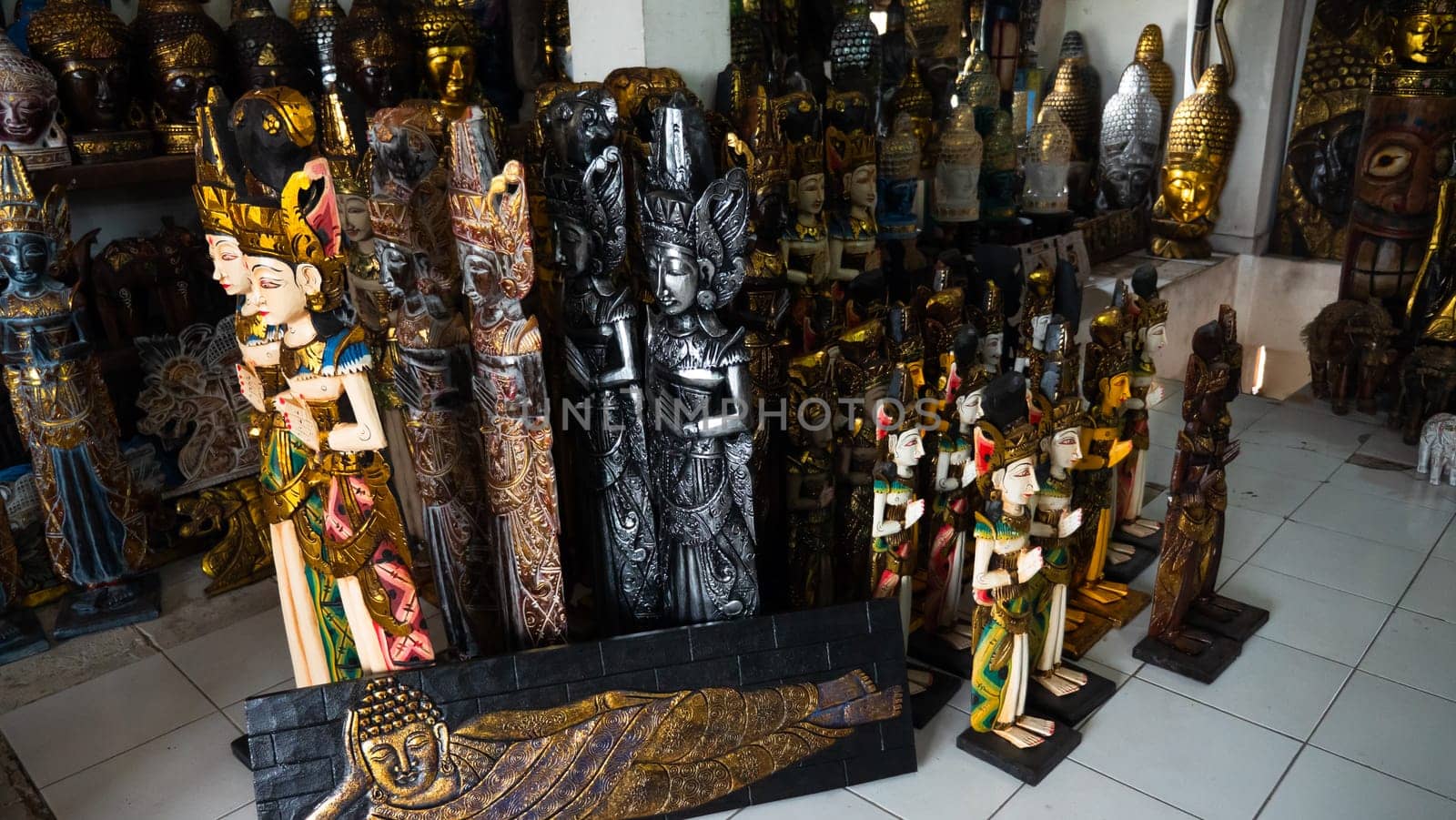 Hindu and Buddhist wooden carving. souvenir shop selling souvenirs and handicrafts of Bali at famous Ubud Market, Indonesia