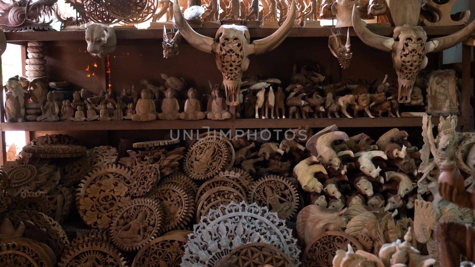 Hindu and Buddhist wooden carving. souvenir shop selling souvenirs and handicrafts of Bali at famous Ubud Market, Indonesia