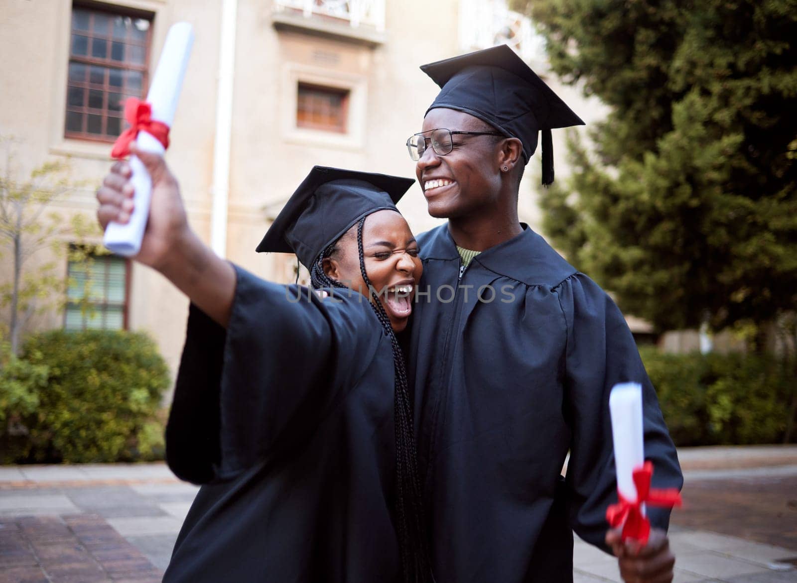 Black students, hug and celebration for graduation, education and achievement on university, campus and success. African American woman, man or academics with smile, embrace or joy for college degree by YuriArcurs