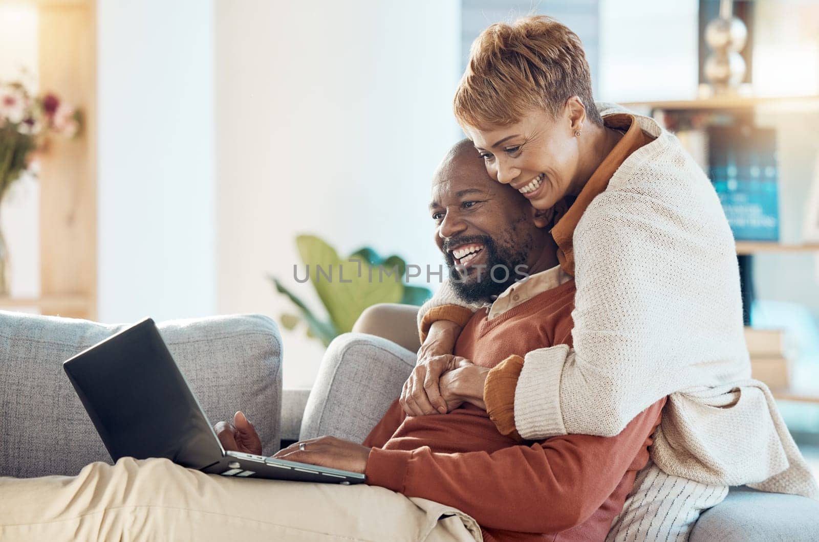 Black couple, laptop and hug together with technology at home, watching a film or video call with 5g network. Black man, black woman and spending quality time on sofa, connection and streaming online.