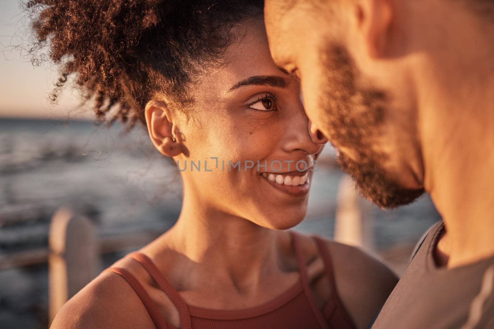 Black couple, smile and hug with forehead embracing relationship, compassion or love and care by the beach. Happy man and woman touching heads smiling in happiness for support, trust or romance.