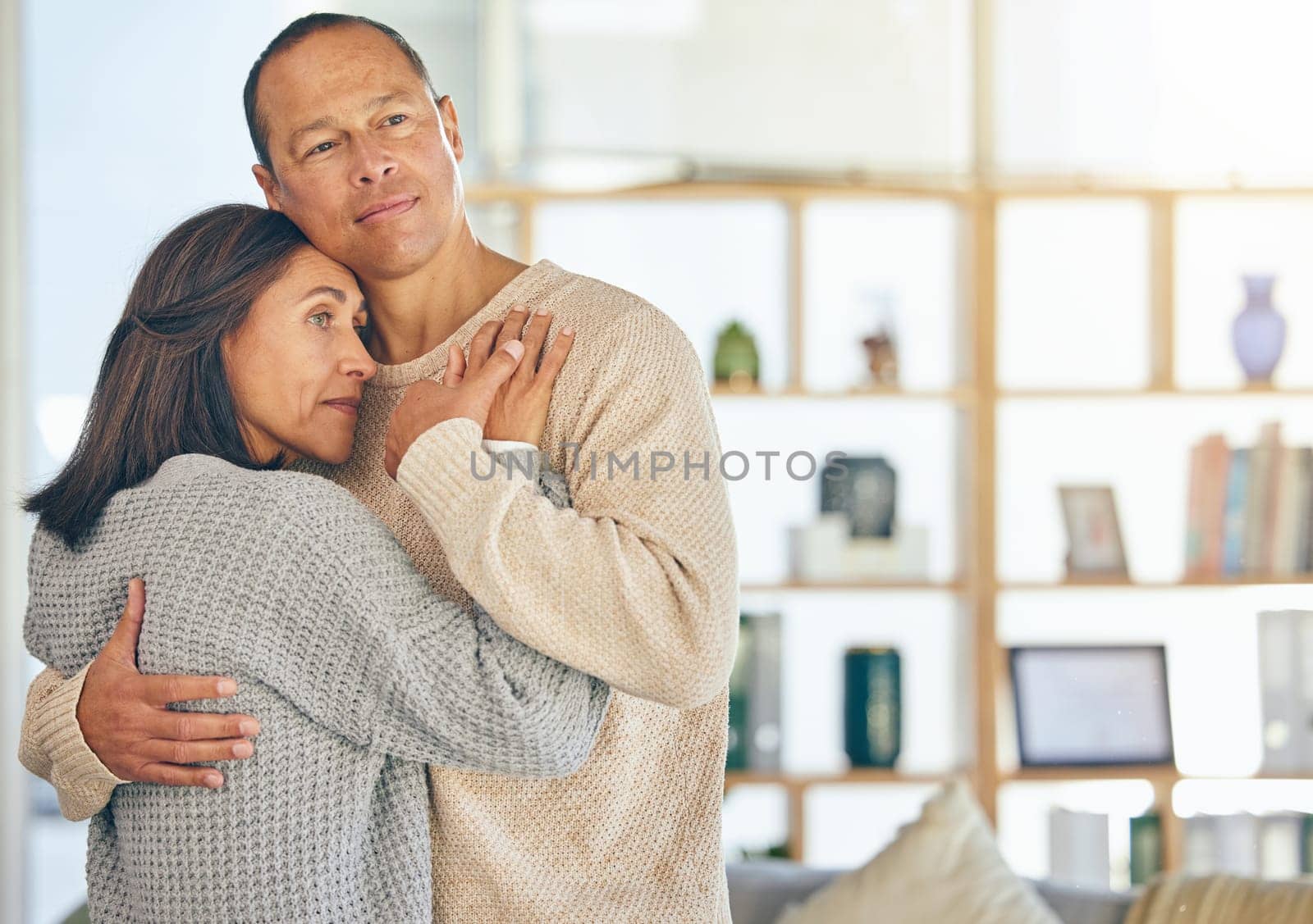 Love, romance and married with a couple hugging while standing in their home together with mockup or flare. Affection, bonding and hug with a mature man and woman embracing in their domestic house.