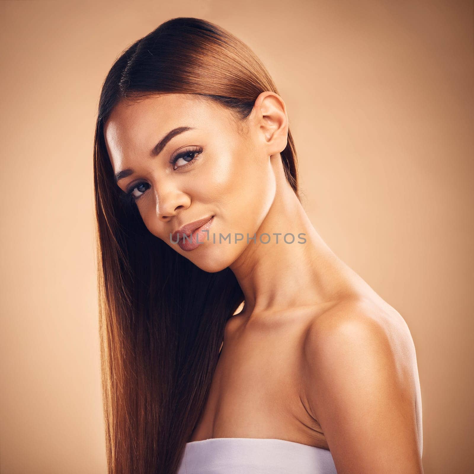 Woman, hair style and wellness in studio portrait with cosmetic beauty, glow and shine by brown background. Girl, latino model and haircare with makeup, health and aesthetic with growth by backdrop.