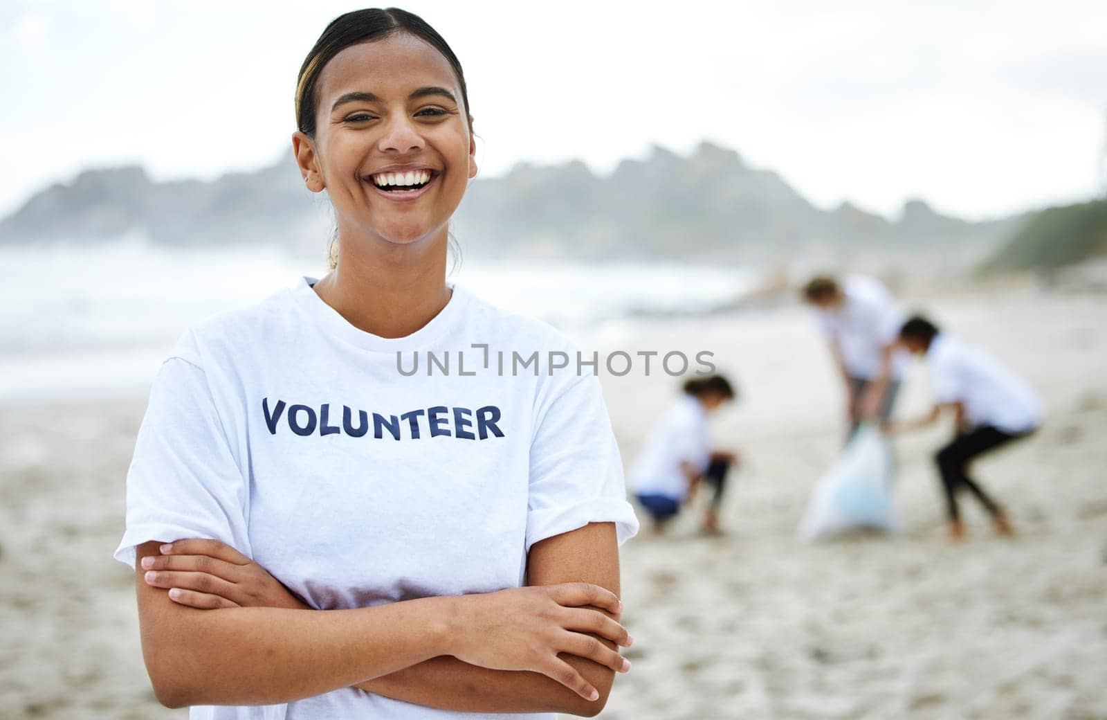 Smile, portrait and volunteer woman at beach for cleaning, recycling and sustainability. Earth day, laughing and proud female with arms crossed for community service, charity and climate change. by YuriArcurs