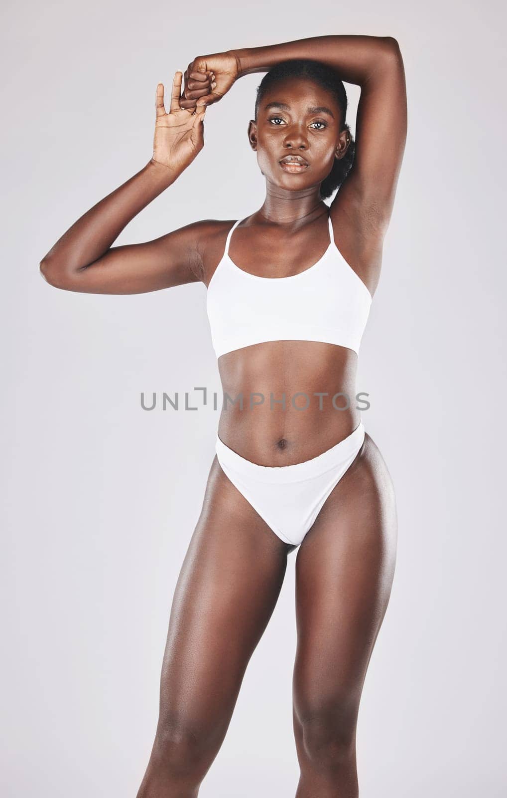 Black woman, body and diet for health, wellness and to lose weight for fitness and a healthy lifestyle and mindset. Portrait of aesthetic african, model in studio with a slim stomach after exercise by YuriArcurs