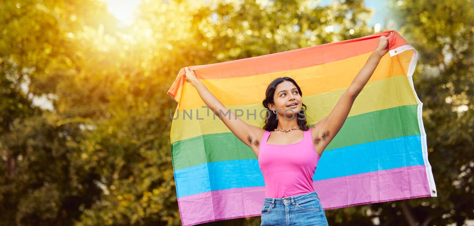 Love, nature and woman with pride flag, smile happy non binary lifestyle of freedom, peace and equality in Brazil. Trees, sun and summer fun for happy woman in lgbt community with flag for gay pride