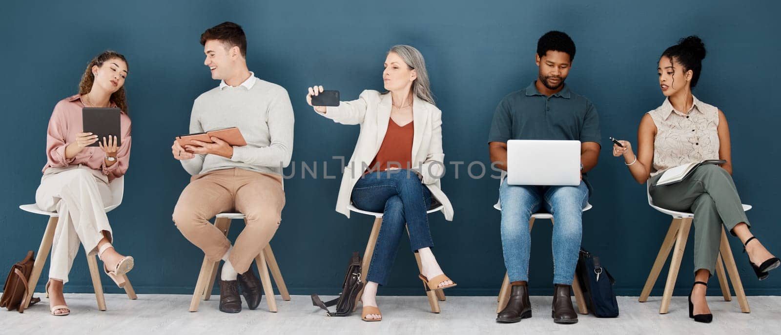 Hiring, technology and business people waiting for job interview, vacancy and opportunity in office. Recruitment, diversity and men and women on phone, tablet and laptop to prepare for hr meeting.