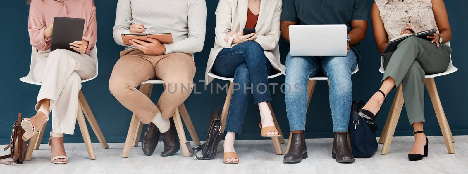 Technology, diversity with group of people and sitting together. Laptop, smartphone and tablet. Social networking or media, connectivity or streaming media and colleagues with tech sit on chair.