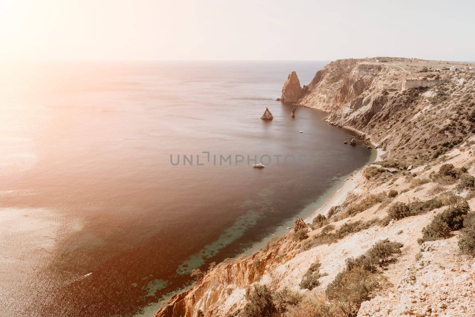 Aerial view from above on calm azure sea and volcanic rocky shores. Small waves on water surface in motion blur. Nature summer ocean sea beach background. Nobody. Holiday, vacation and travel concept by panophotograph