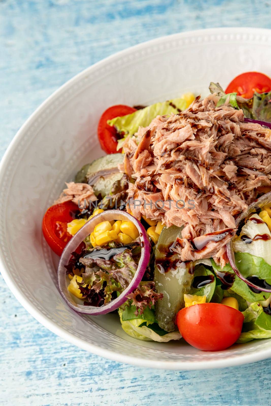 Healthy diet food tuna salad on white porcelain plate