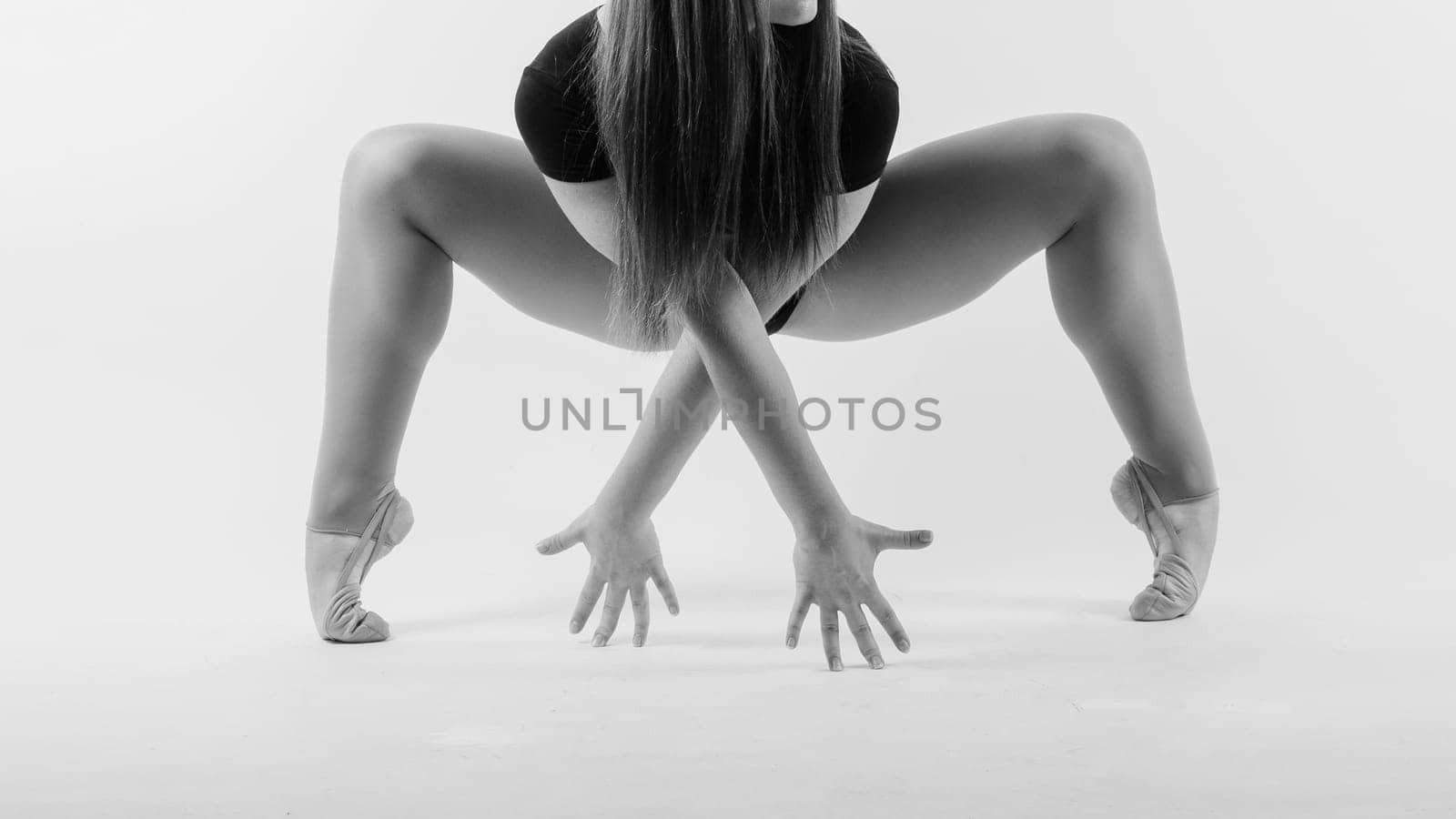 Young beautiful dancer posing on studio background with copy space