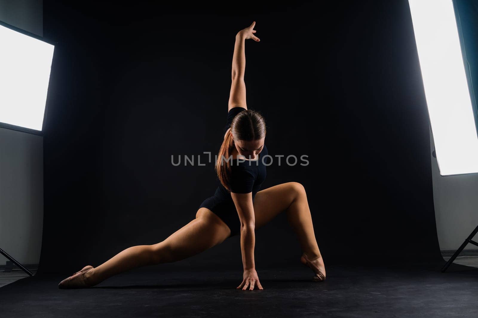 Young beautiful dancer posing on a studio background with copy space by Zelenin