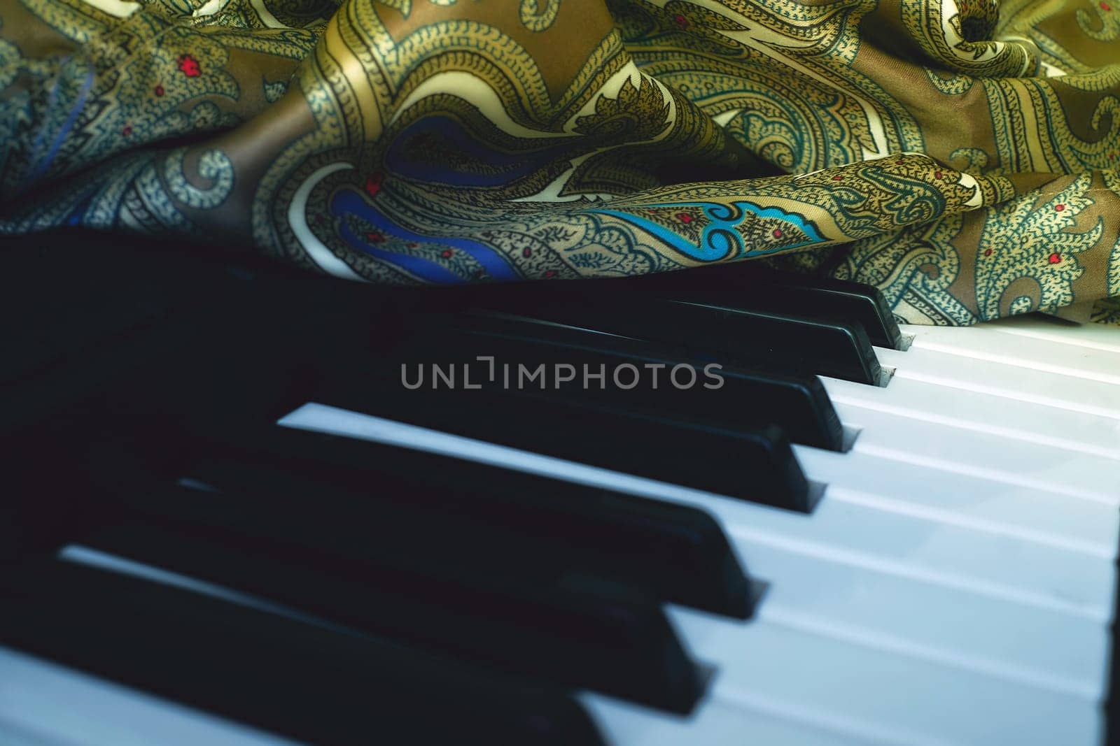 Silk green fabric textile with blue inserts and black and white piano keys by jovani68