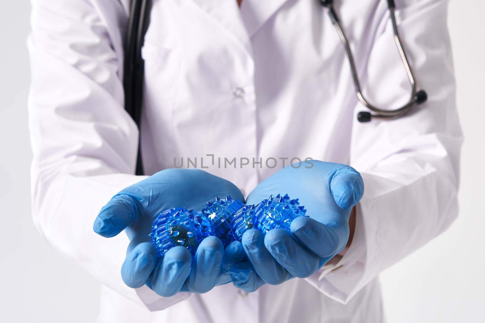 Doctor holding in hands wearing medical gloves three-dimensional model of virus - coronavirus COVID-19