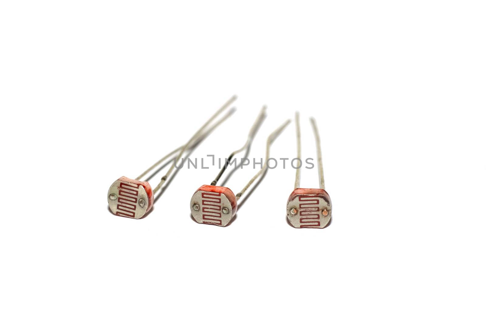 Three photoresistors isolated on a white background close up