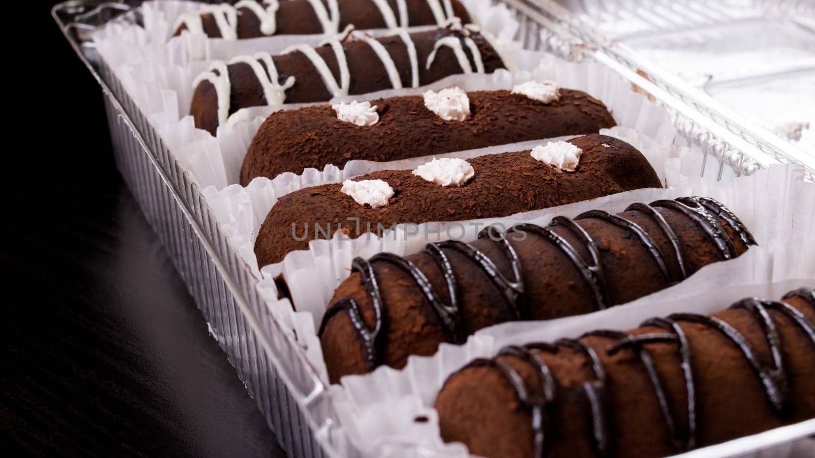 Chocolate cakes with cream close up on wooden table