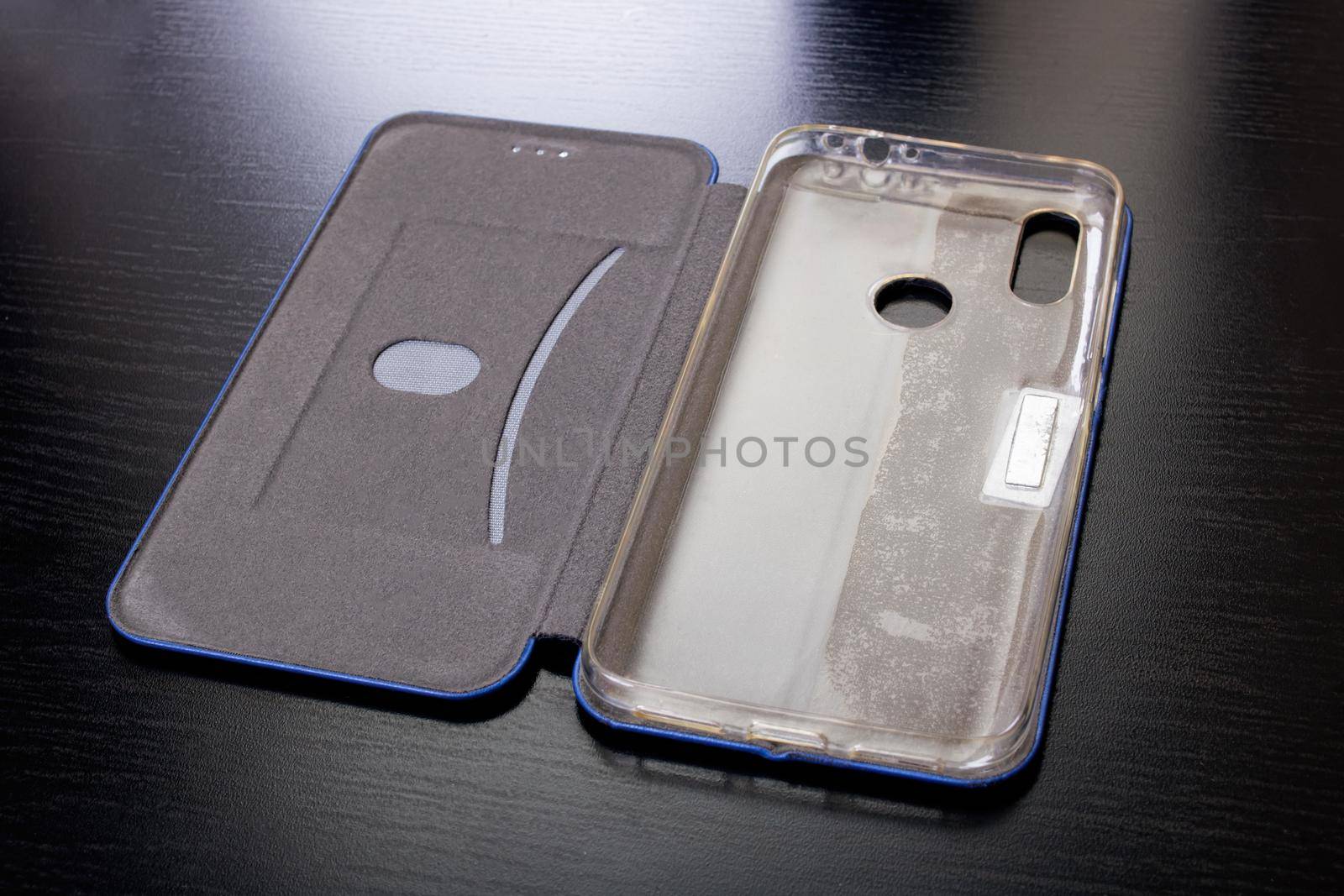 Gray phone case on a wooden table close up