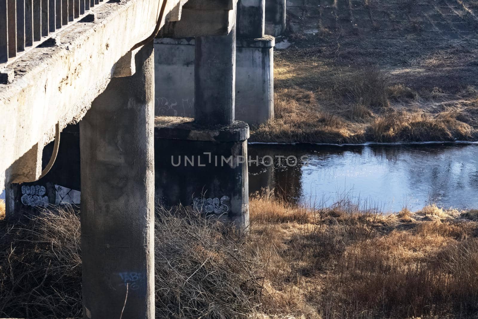 Small river under the old bridge in autumn