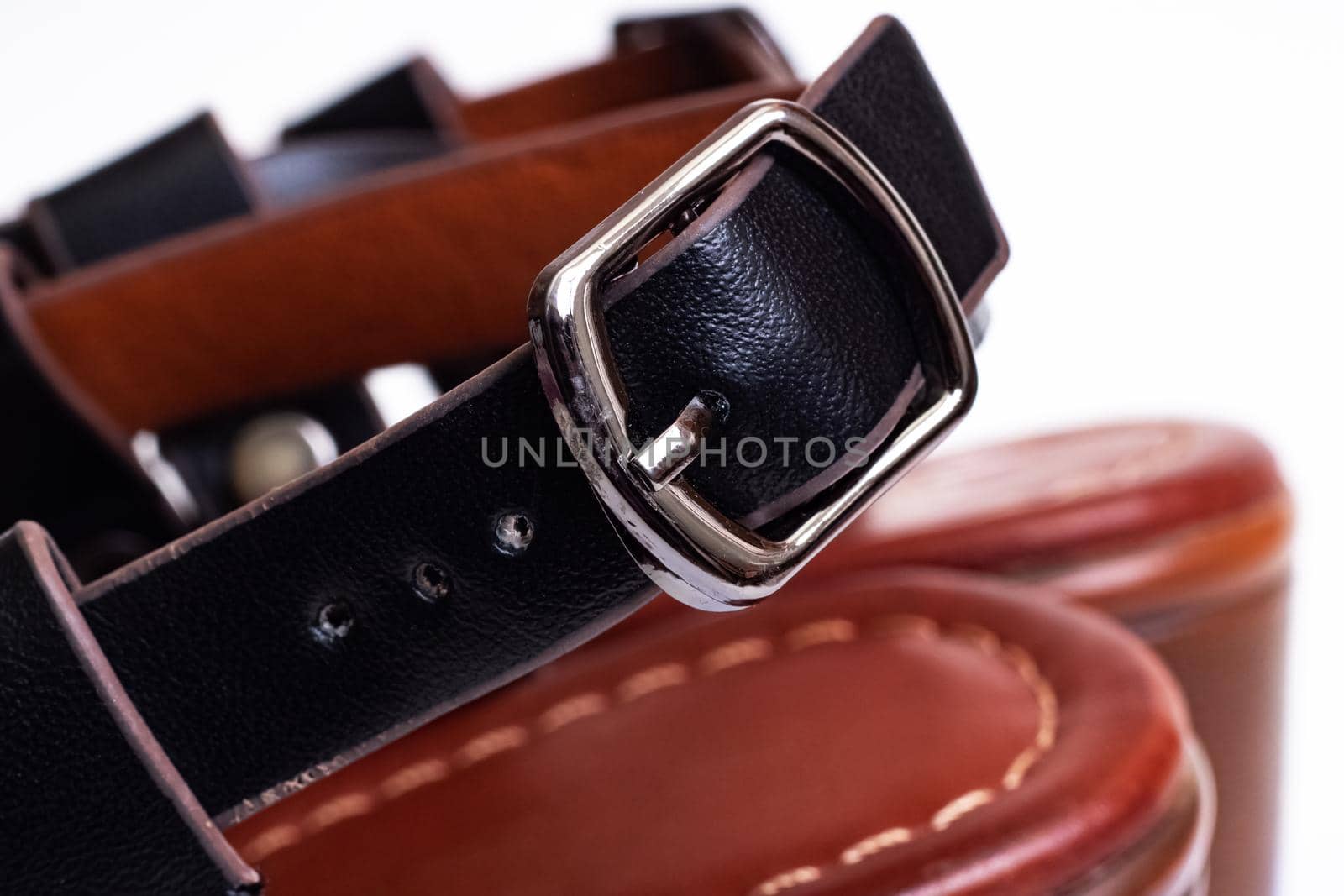 Clasp and strap on black women's sandals on a white background close up