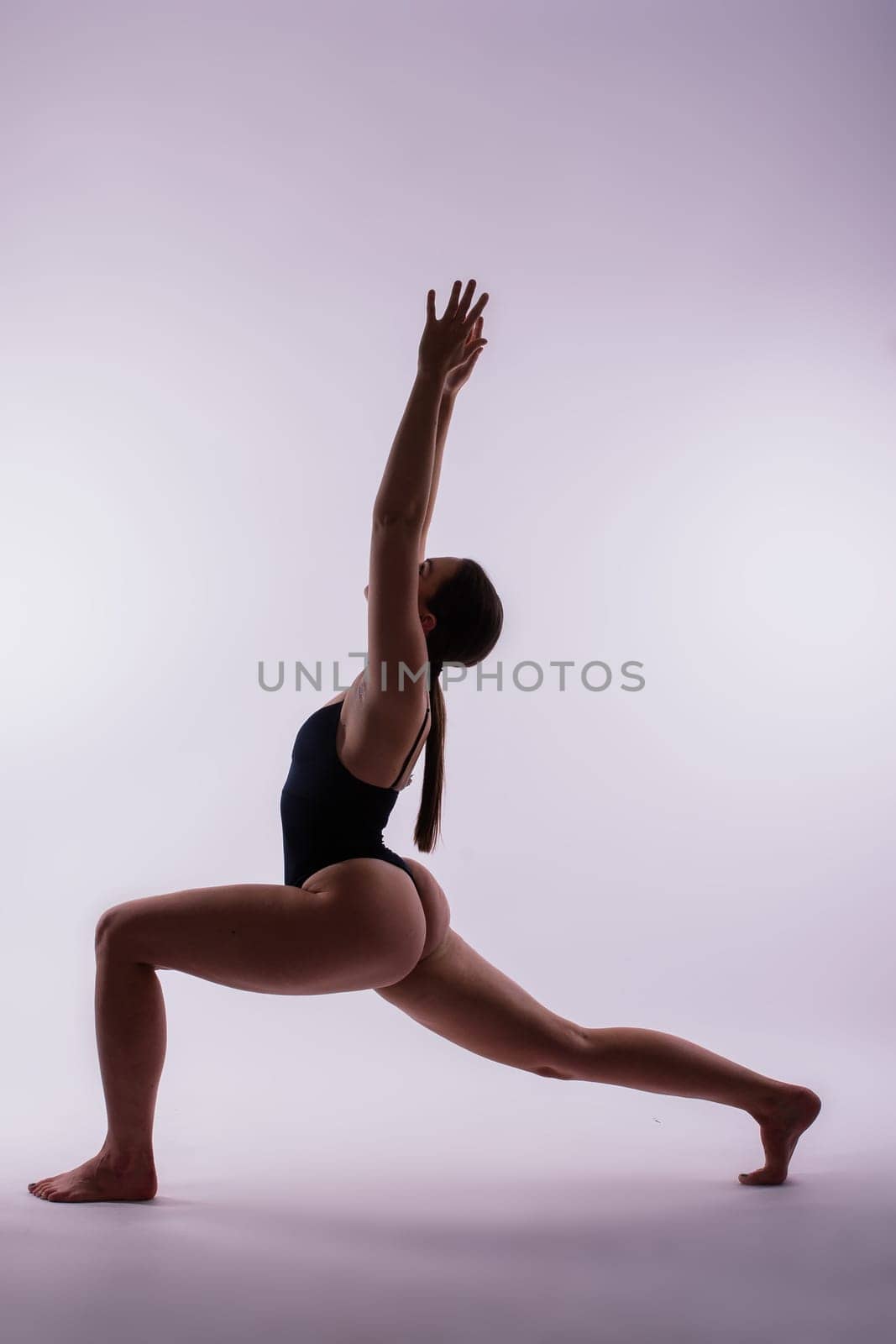 Image of young plump female doing acrobatic stunt, studio shot by Zelenin