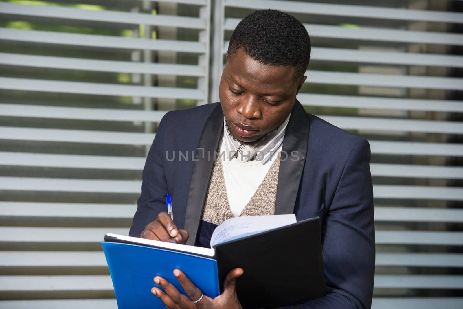 Portrait of businessman writing information on how to develop his project. Business people, industrial, investment concept.