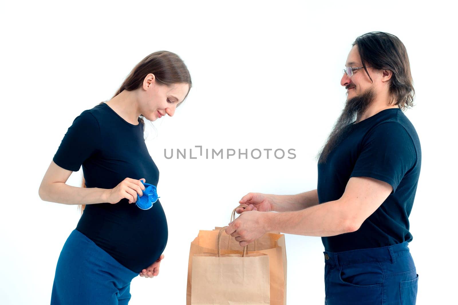 pregnancy, shopping, parenthood and happiness concept - happy young family with shopping bags by kajasja