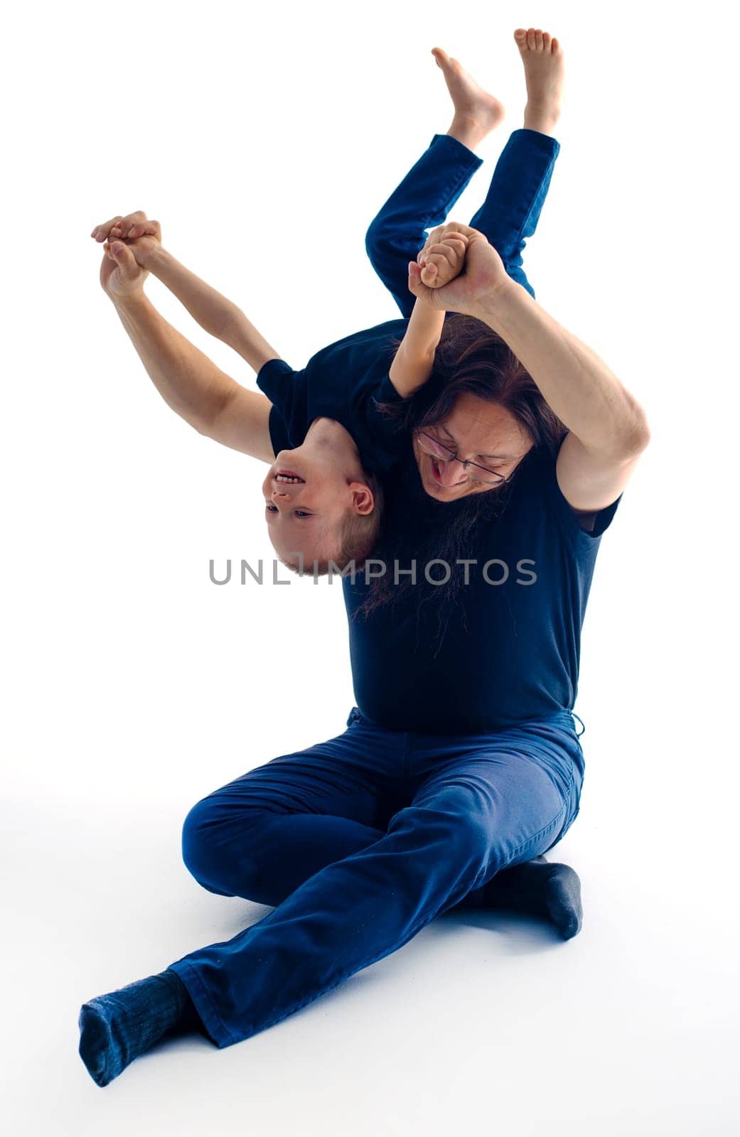 young handsome father with his son fooling around, lifestyle on white background. High quality photo