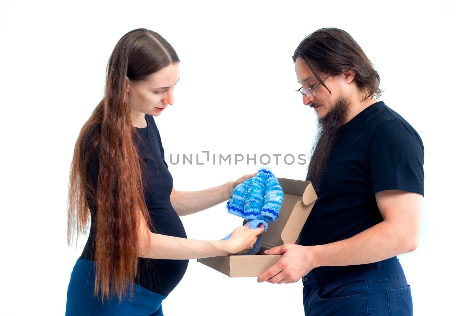 Portrait happy young pregnant woman and her husband with shopping bags and touching her big belly isolated on white background. Pregnancy shopping concept happy young family with shopping bags