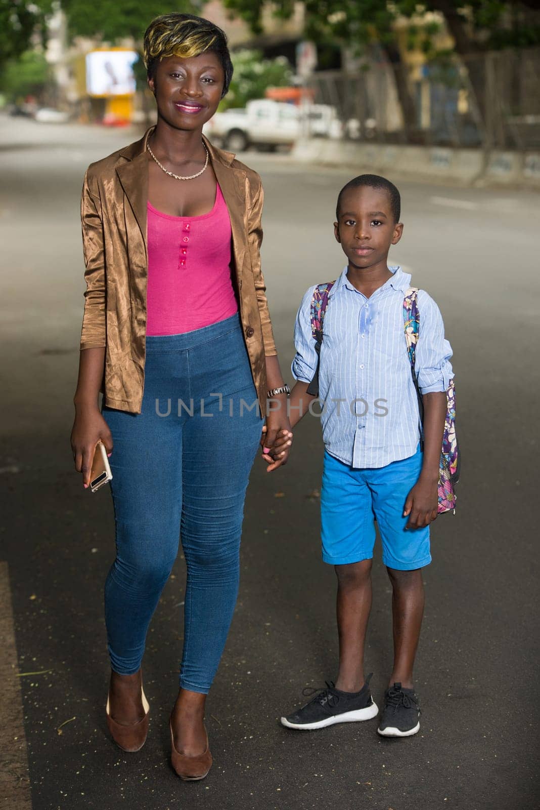 woman and son on the way to school. Child going back to school. Start of the new school year after the summer holidays. little boy with backpack returns to school accompanied by his mother. Beginning of the course