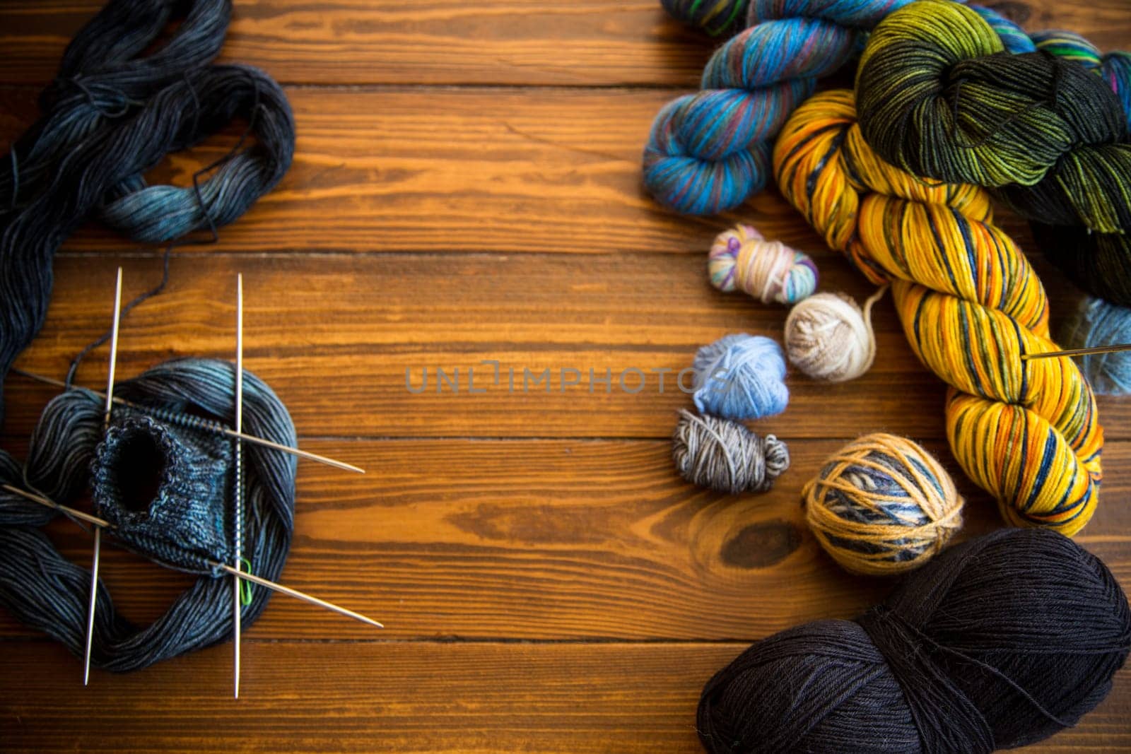 Colored threads, knitting needles and other items for hand knitting by Rawlik