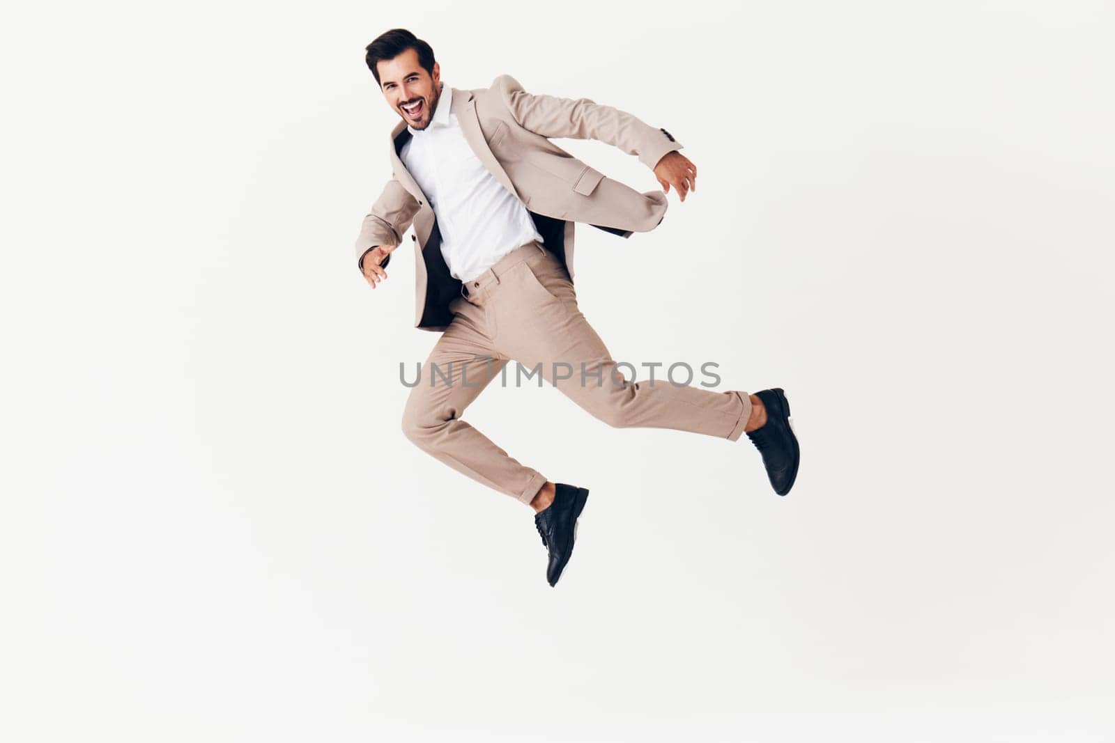 man smiling victory business jumping businessman beige suit running happy winner by SHOTPRIME