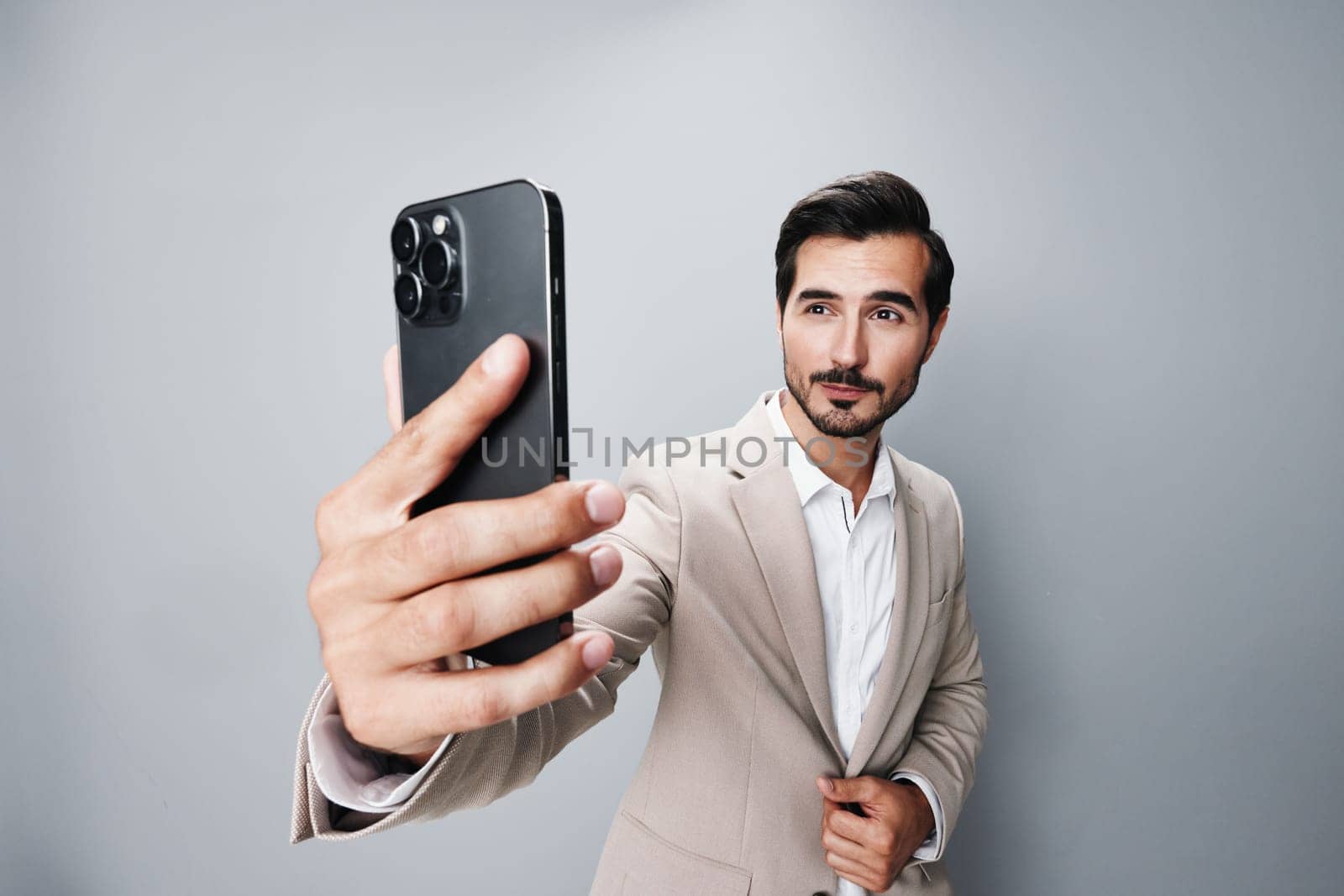 man blogger hold gray internet suit happy corporate smile white connection young business phone portrait selfies lifestyle guy smartphone cellphone call