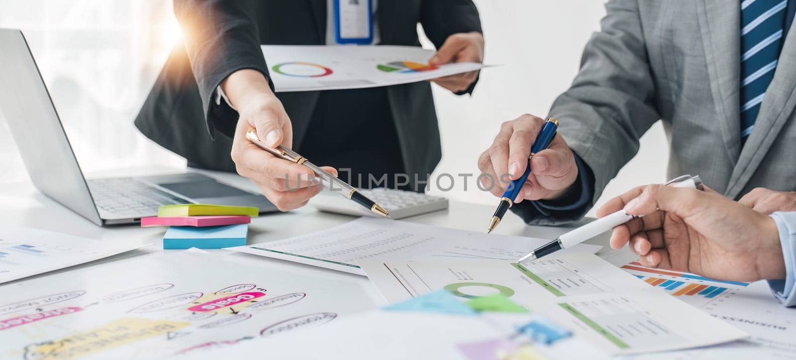 Business People Meeting using laptop computer,calculator,notebook,stock market chart paper for analysis Plans to improve quality next month. Conference Discussion Corporate Concept.. by wichayada