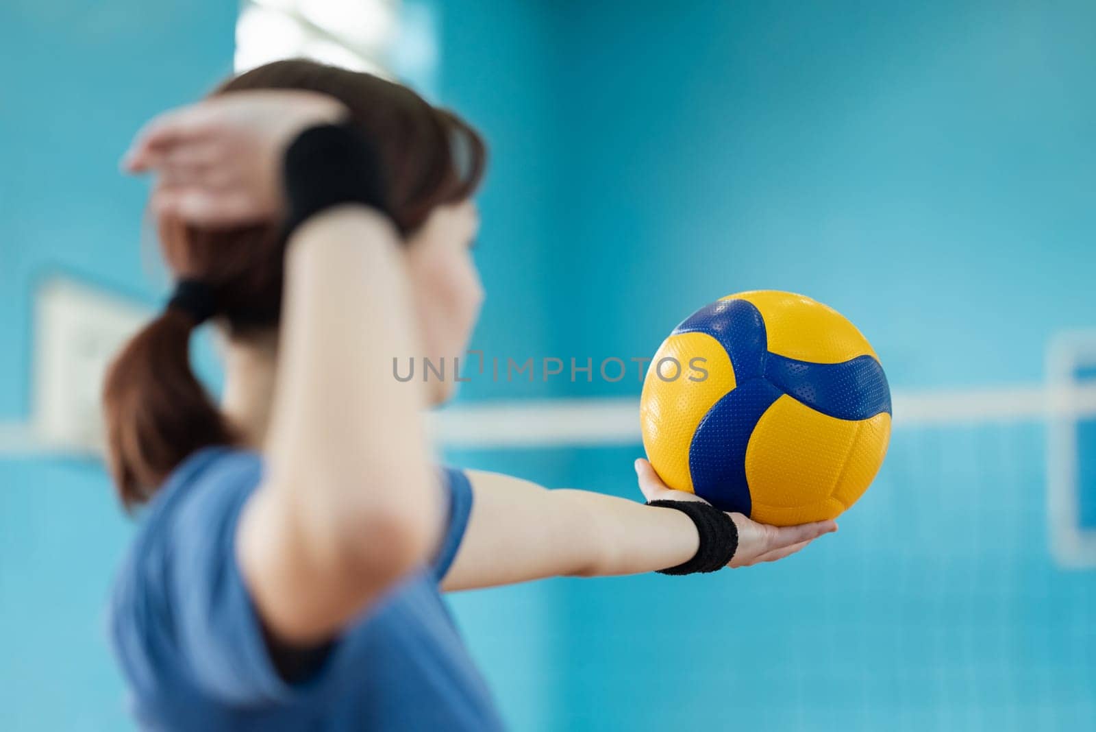 Female learner mastering skills in volleyball, practice serving
