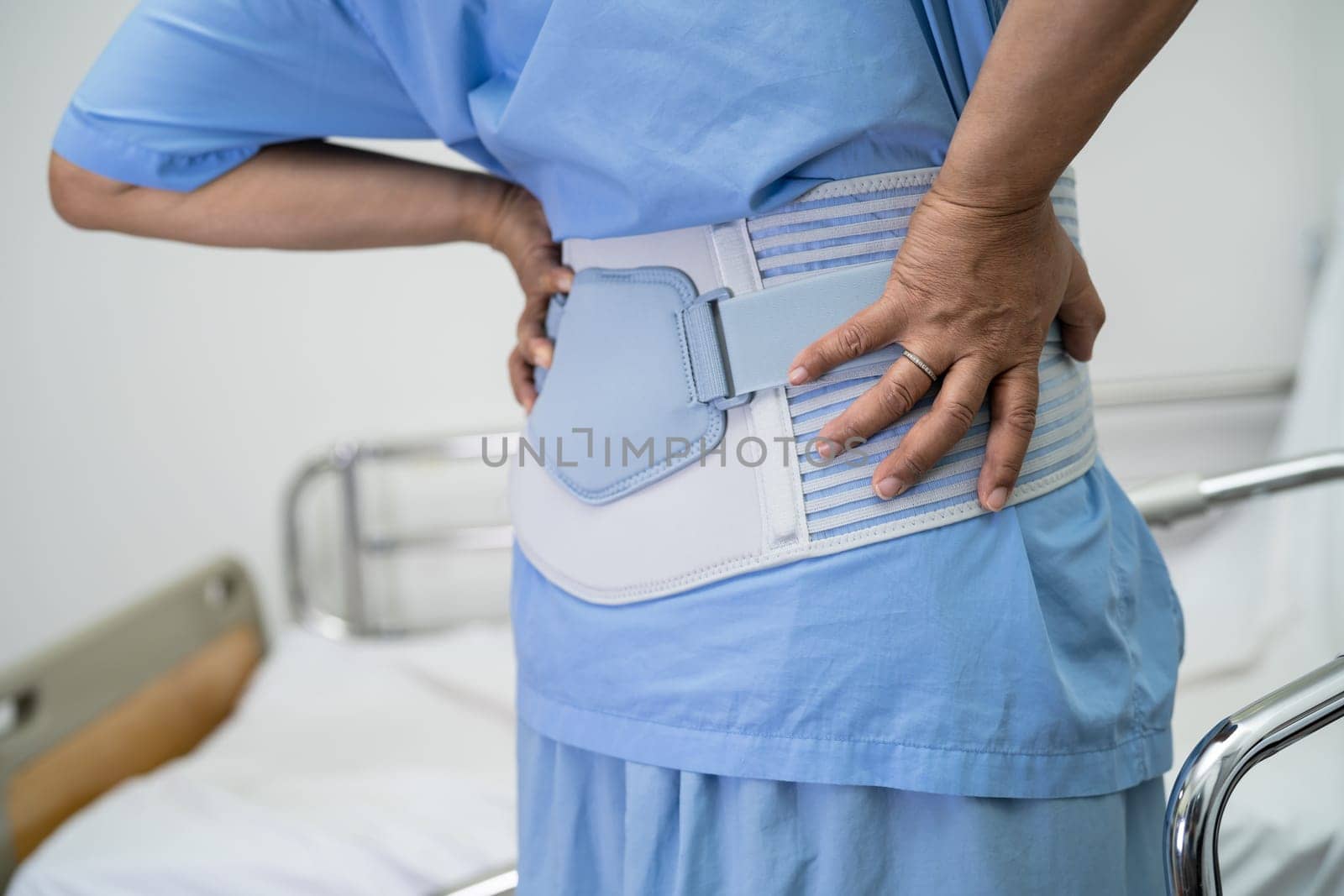 Asian lady patient use walker in hospital to support walking.