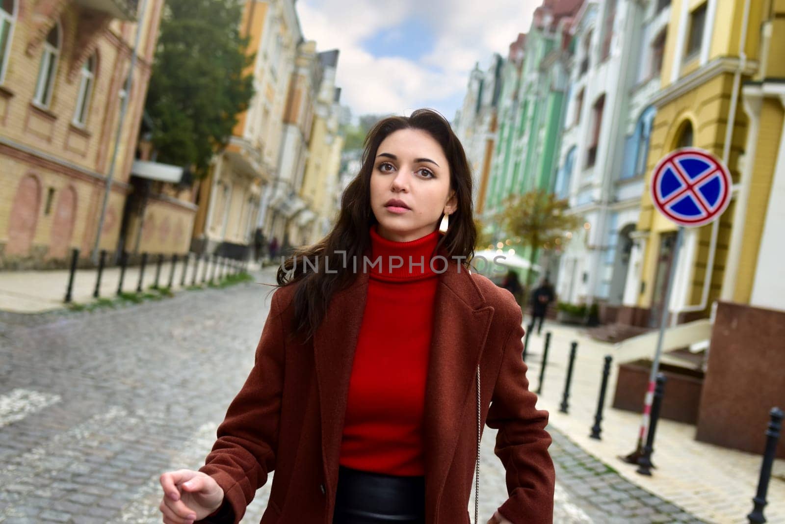 Young stylish woman stares anxiously. A woman walks down the street anxiously looking ahead.