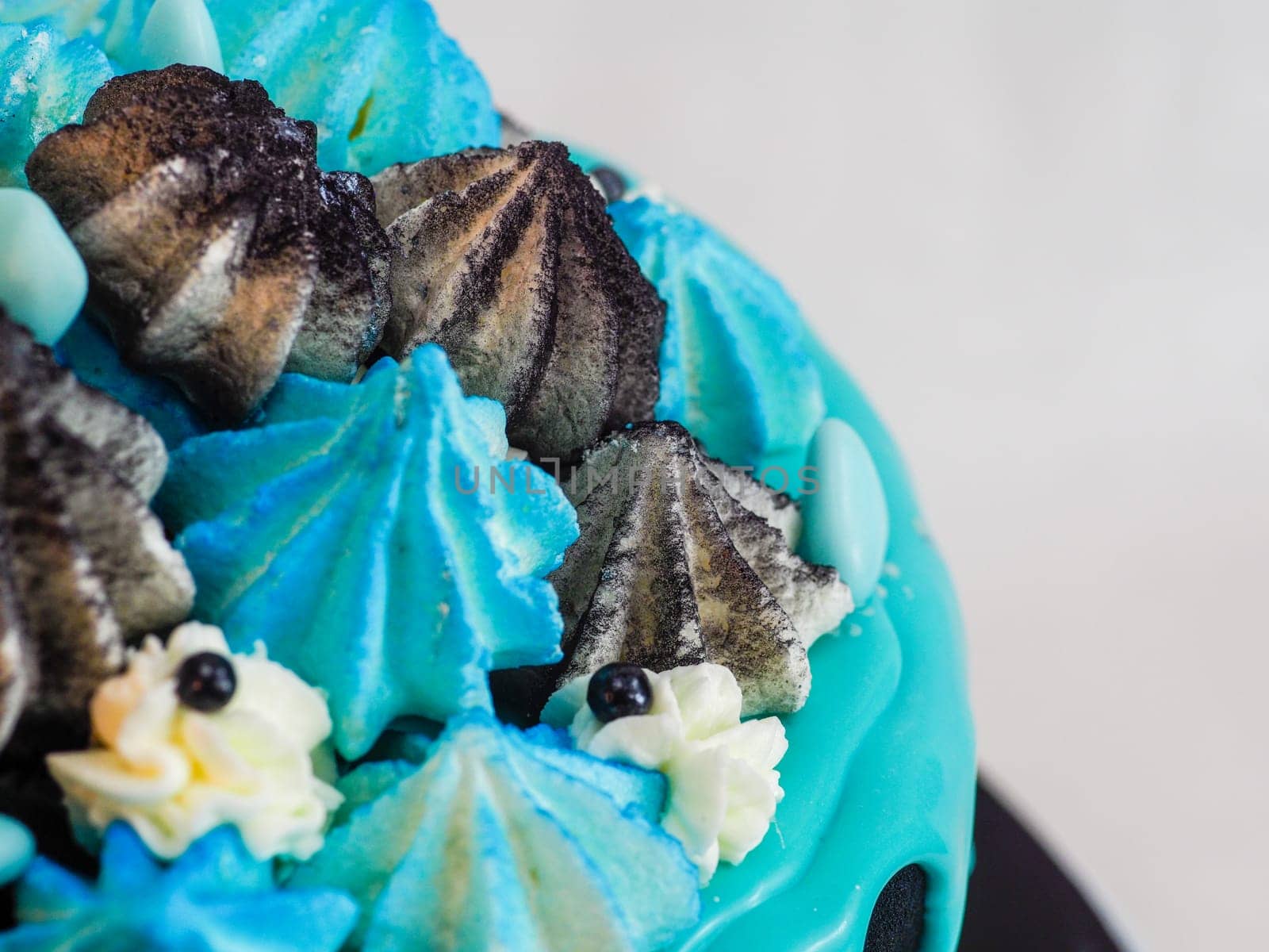 frosted black painted cup cake with blue turquoise dripping by verbano