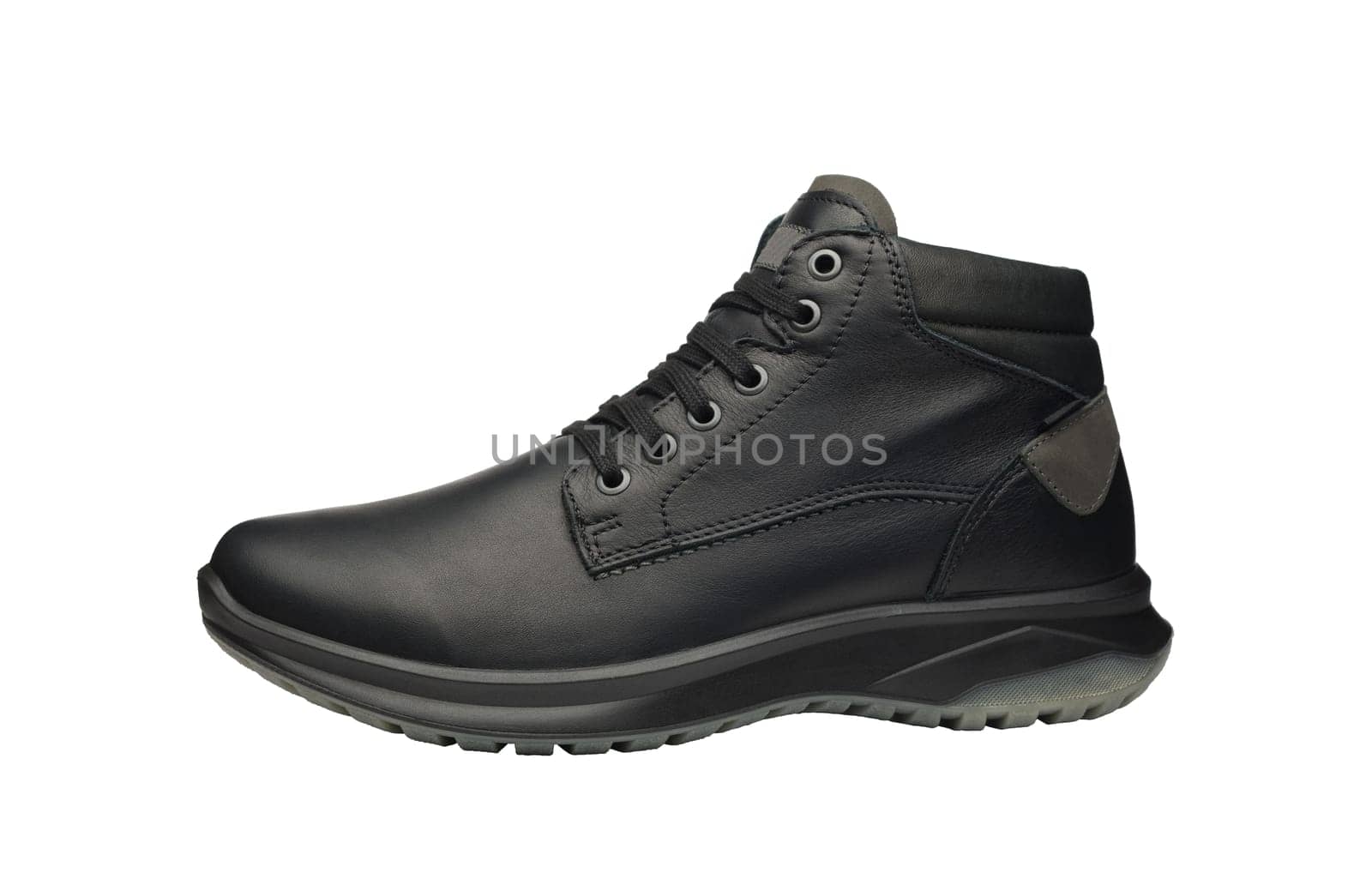 Men leather waterproof winter trekking shoe isolated on white background. New sports hiking boot with shoelaces - side view. Unisex shoes for cold weather. Full depth of field. High quality photo