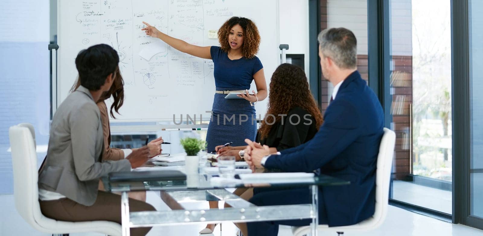 Its right there. a young businesswoman giving a presentation in the boardroom