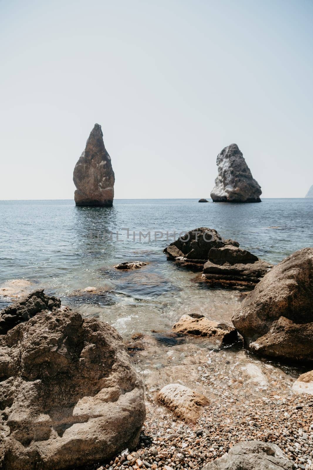 Aerial view from above on calm azure sea and volcanic rocky shores. Small waves on water surface in motion blur. Nature summer ocean sea beach background. Nobody. Holiday, vacation and travel concept by panophotograph