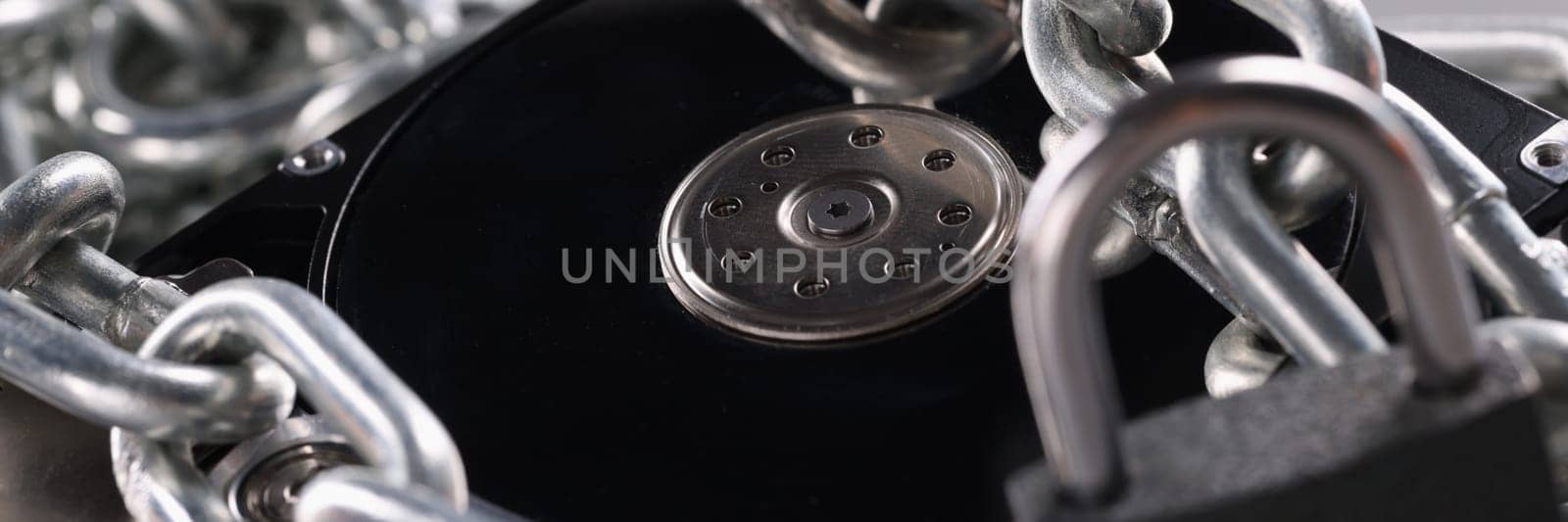 Computer hard drive with chain lock closeup by kuprevich