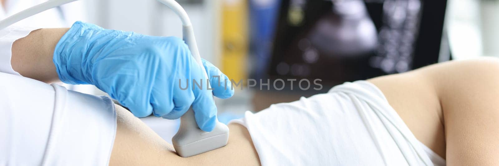Doctor examines patient with prolapse of left kidney and spleen using ultrasound probe. Ultrasound diagnostics of soft tissues and organs concept