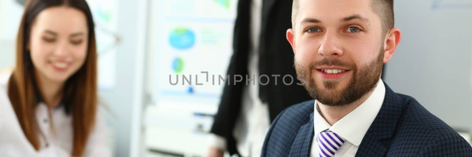 Portrait of handsome young man at business meeting. Joint successful teamwork concept