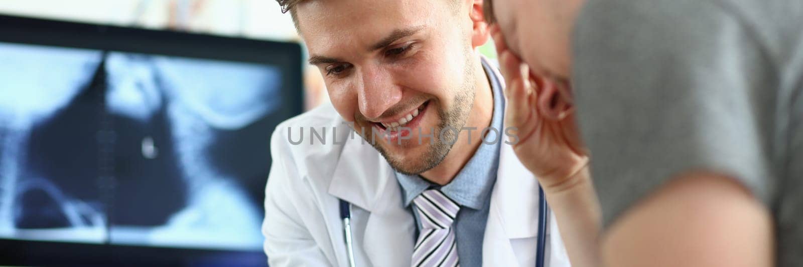 Doctor shows results of medical examination on tablet to sad patient. Communication doctor with persons in clinic