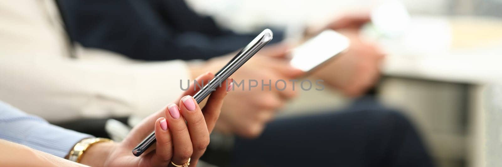 Closeup of business people hands are holding smartphone by kuprevich