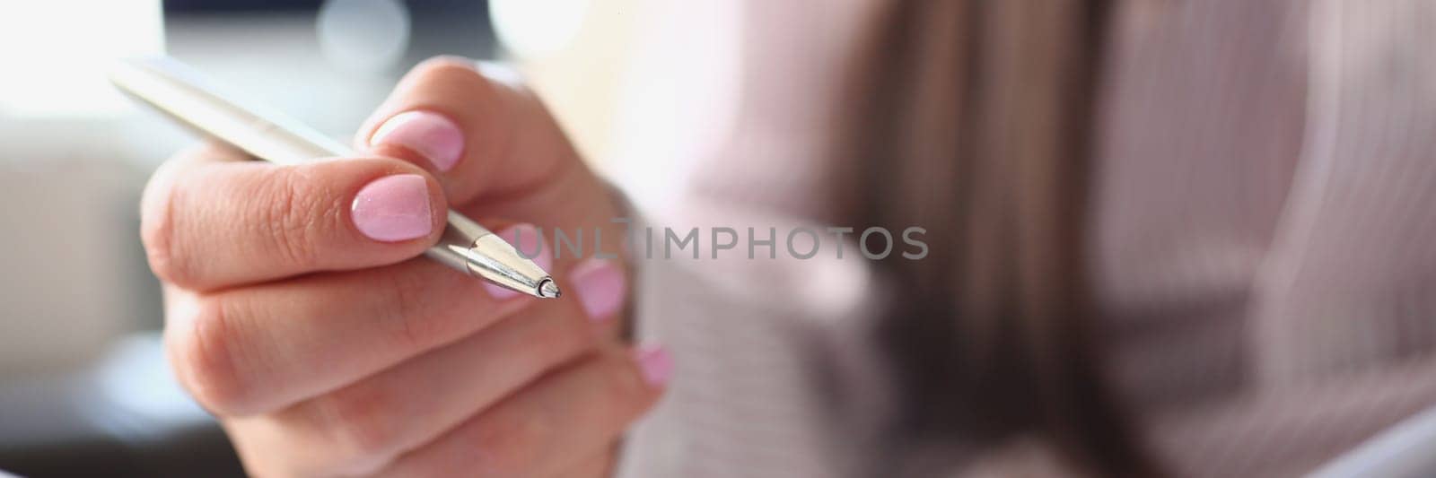 Woman hand holds pen and diary closeup by kuprevich