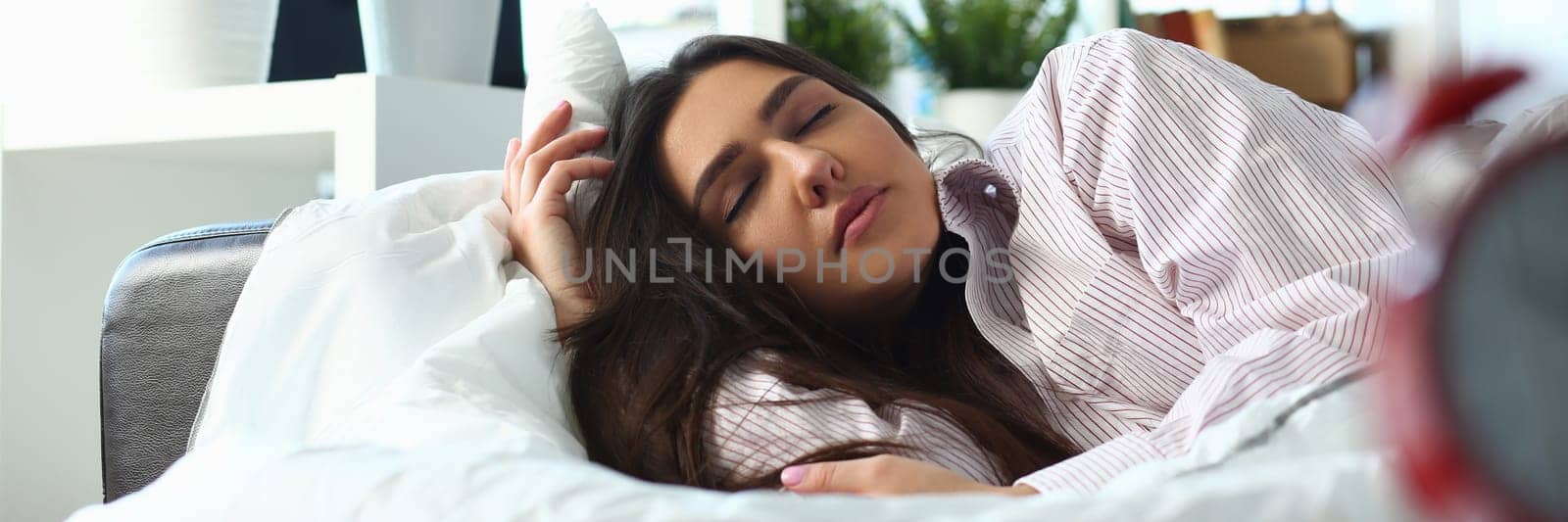 Sleepy woman with closed eyes dreaming about future vacation or sleeping in the bedroom by kuprevich