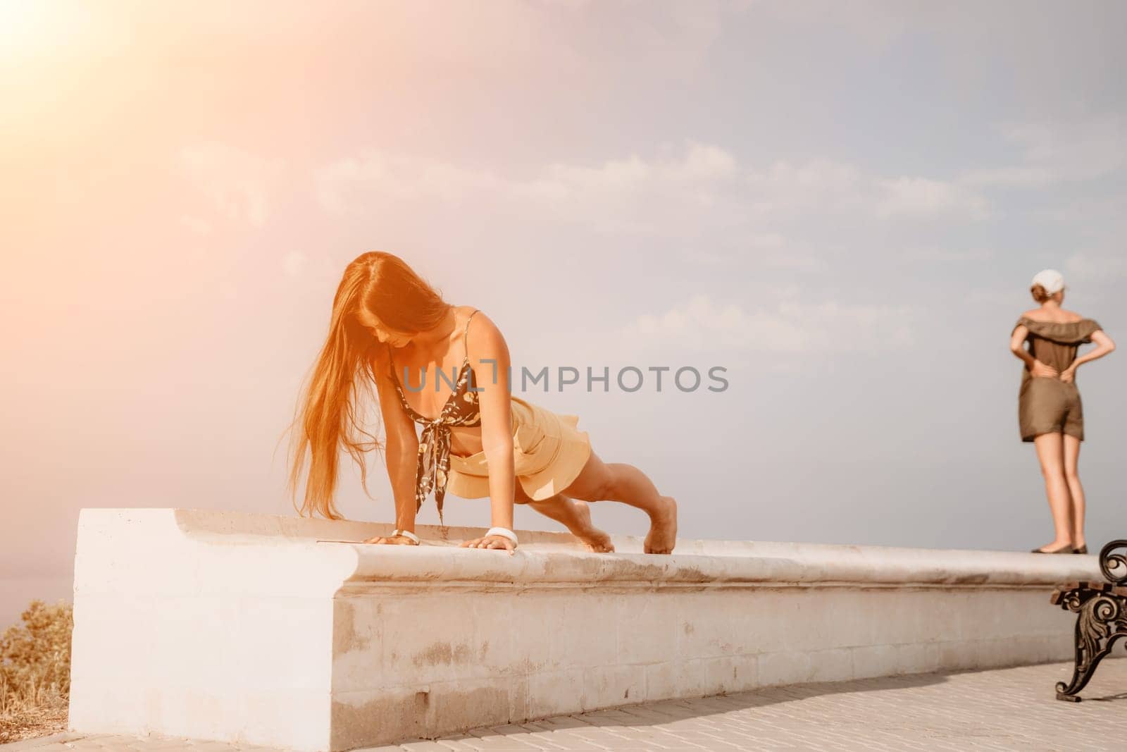 Woman park yoga. Side view of free calm bliss satisfied woman with long hair standing in morning park with yoga position against of sky by the sea. Healthy lifestyle outdoors in park, fitness concept. by panophotograph